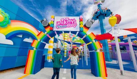 Kids walking through entrance of Unikitty's Disco Drop
