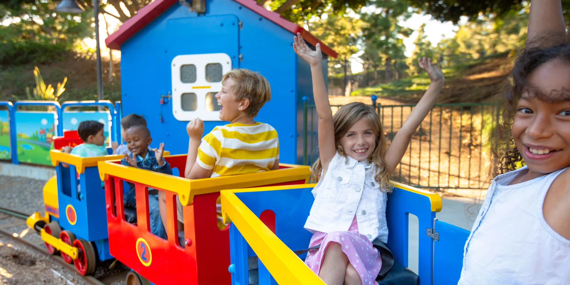 Kids riding on train at DUPLO Playtown