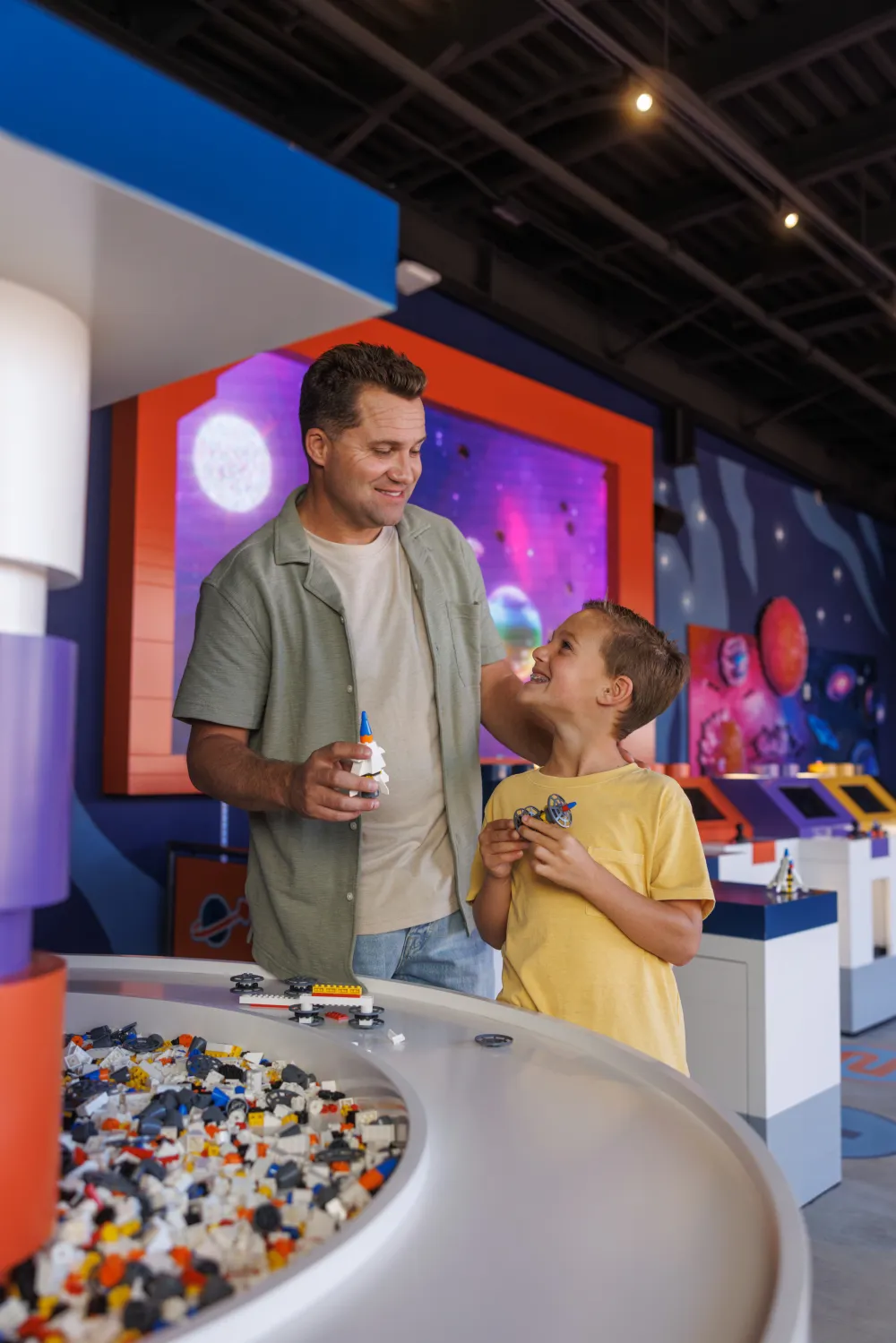 Father and Son building LEGO Rockets at Rocket Assembly Bay