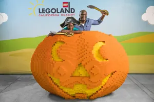 Dad and Son posing with jack-o-lantern