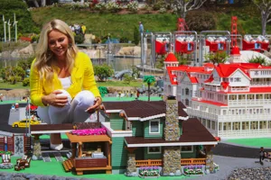 Allie Lutz sits outside LEGO Beach Home in MINILAND at LEGOLAND California
