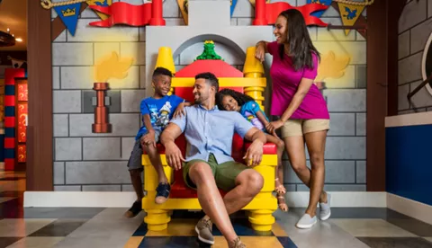 Family sitting around LEGO throne at LEGOLAND Castle Hotel