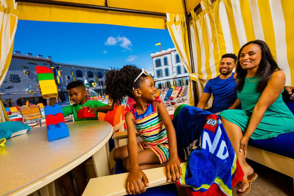 Family enjoys a poolside cabana at the Castle Hotel