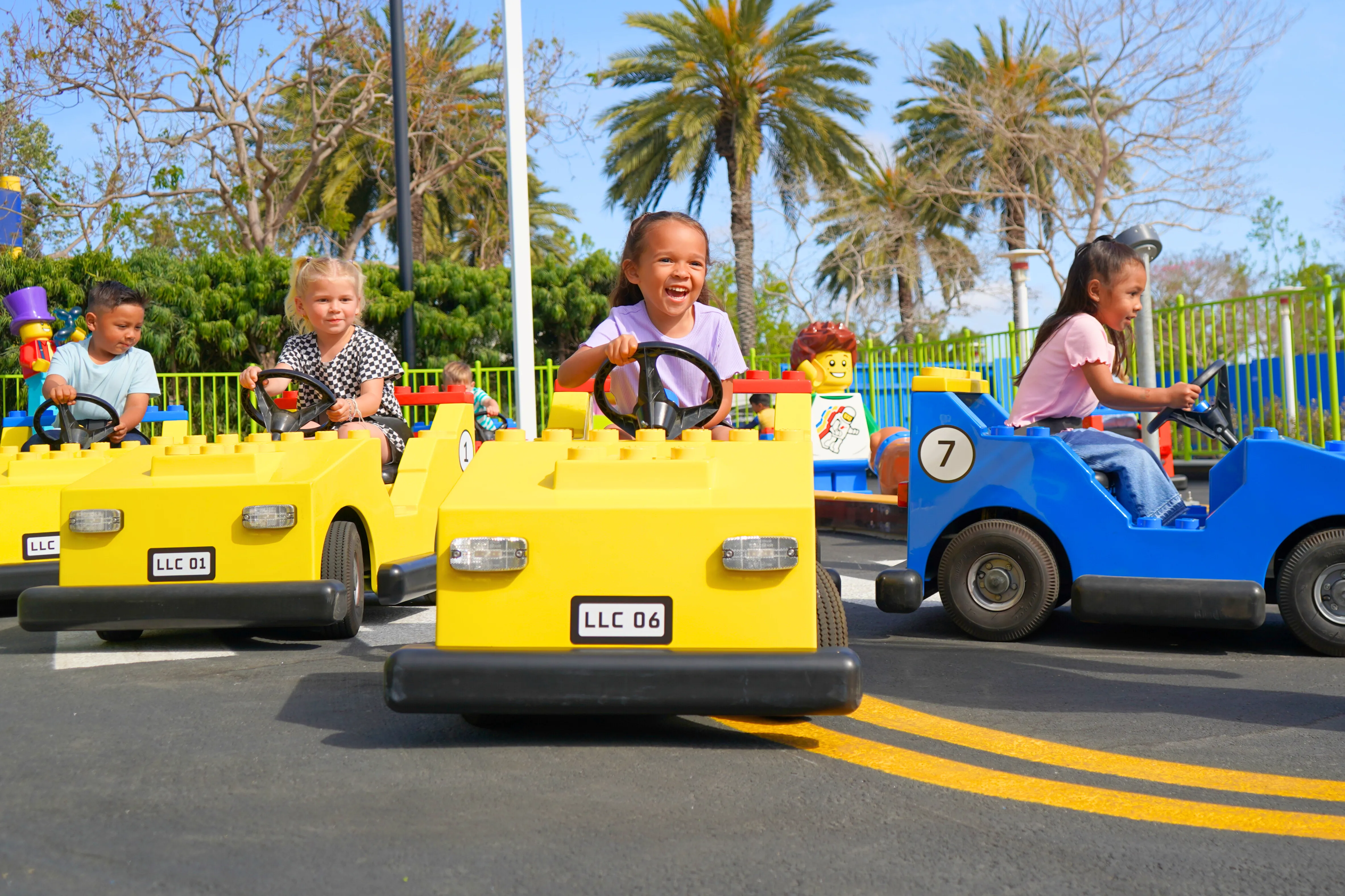 Kids driving on colorful cars at Driving School