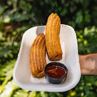 Enjoy churros with chocolate dip as a Park snack