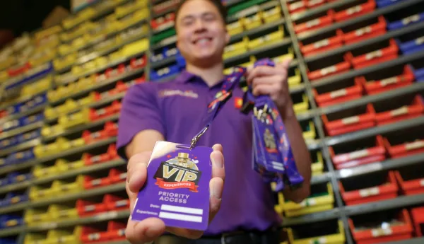 VIP Host holding VIP badge