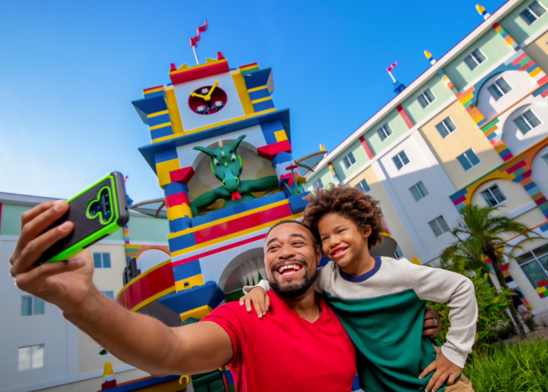 Father and son taking a selfie in front of the Legoland Hotel