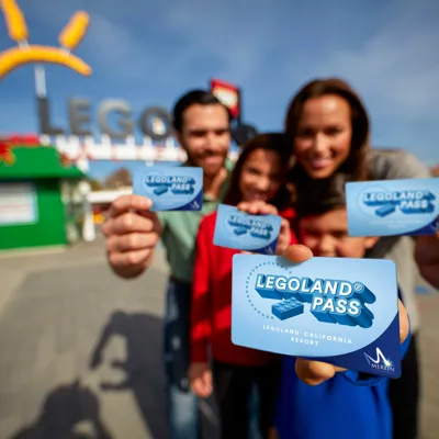 Family showing annual passes at the entrance of LEGOLAND California