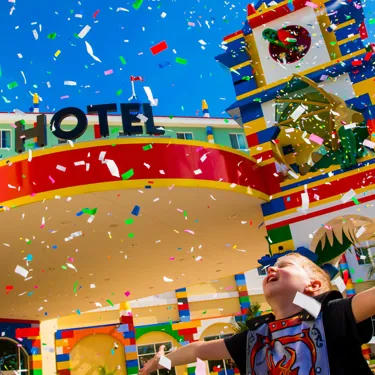 Child celebrating outside LEGOLAND California hotel