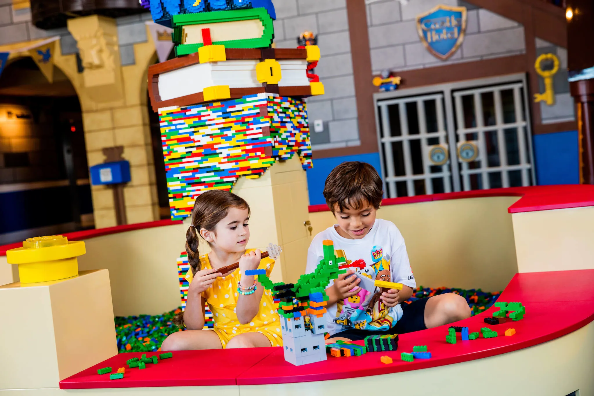 Kids build a LEGO dragon in the Castle Hotel lobby