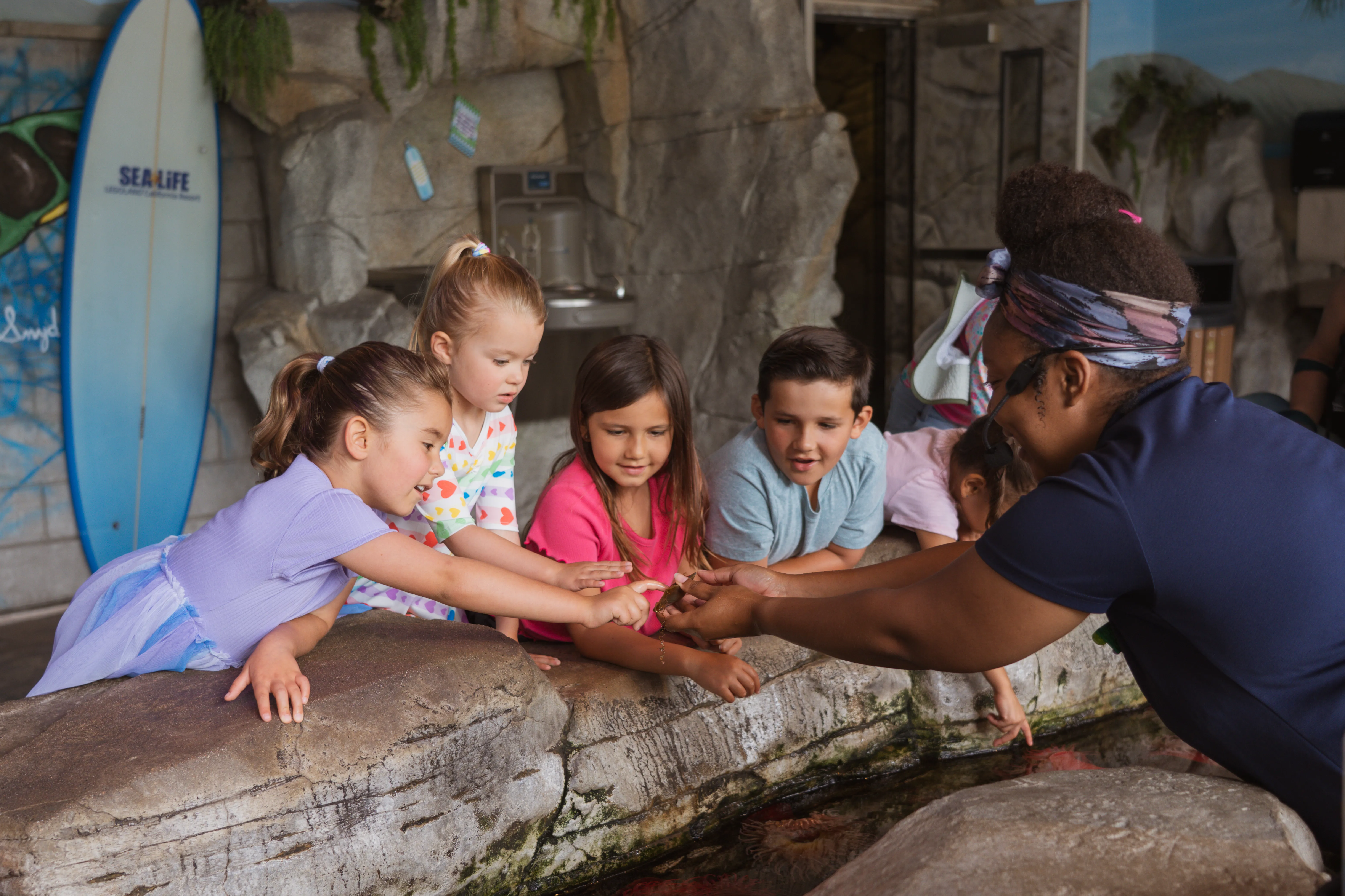 Kids at touchpools in SEA LIFE