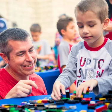 A photo of a father and child building with LEGO Bricks at LEGOLAND Florida Resort