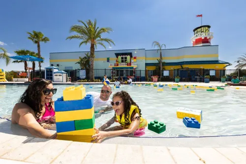 Family enjoying LEGOLAND® Florida resort pool during a 2026 family vacation