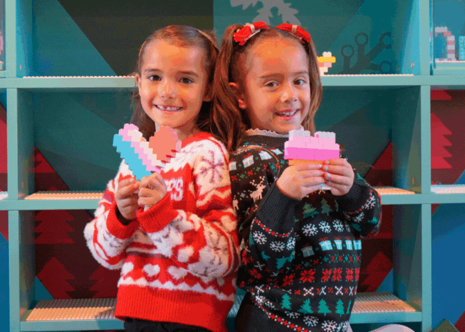 Children taking photos of their LEGO Heart Builds for the Build to Give Event