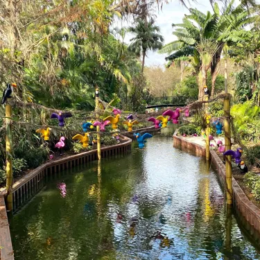 Brightly colored LEGO® birds perched above the waterway of the LEGOLAND® boat ride.