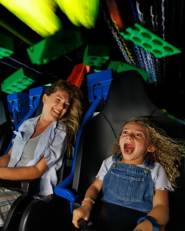 Mother and daughter enjoying the newest indoor rollercoaster ride Galacticoaster at LEGOLAND Florida Theme Park