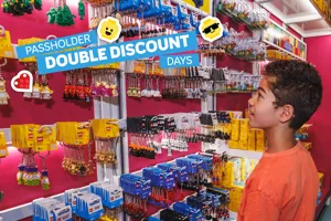 A child browsing LEGO keychains with added text," Passholder Double Discount Days"