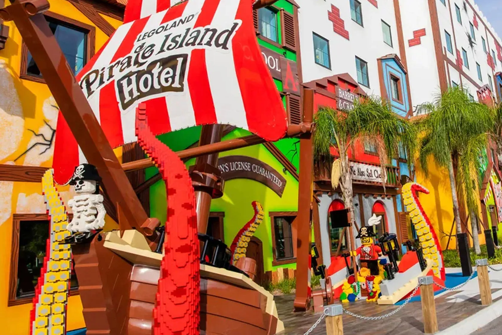 Colourful pirate-themed hotel facade with palm trees
