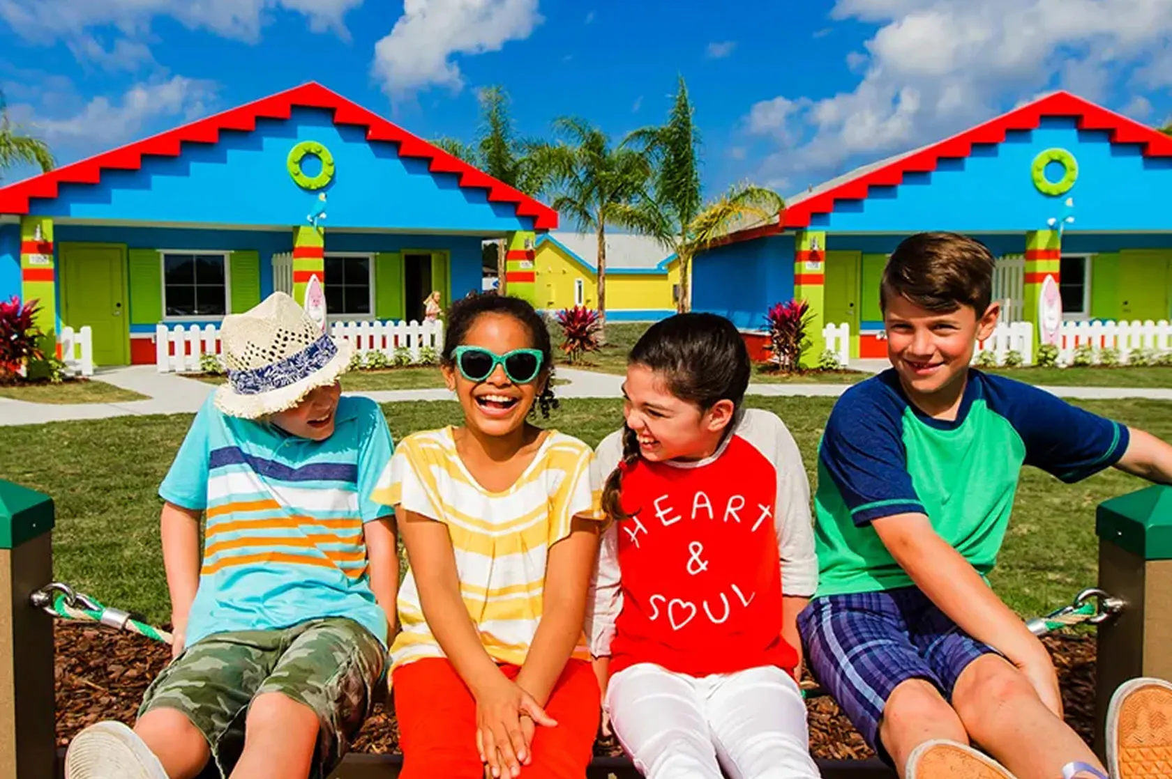 Family relaxing together outside the LEGOLAND Beach Retreat bungalows
