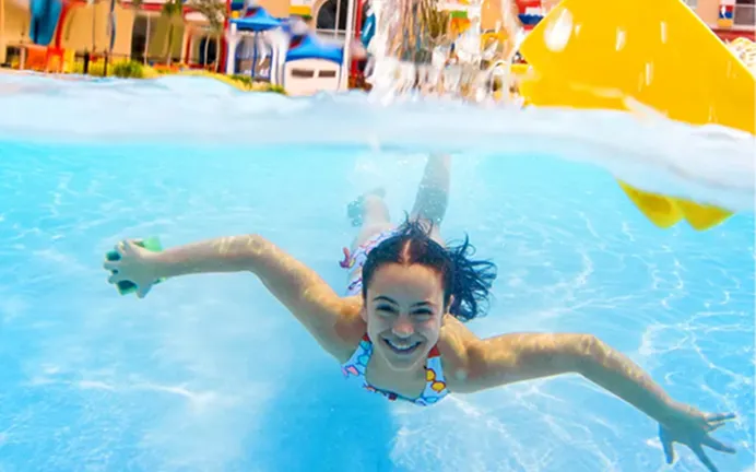 Child swimming in a themed hotel pool