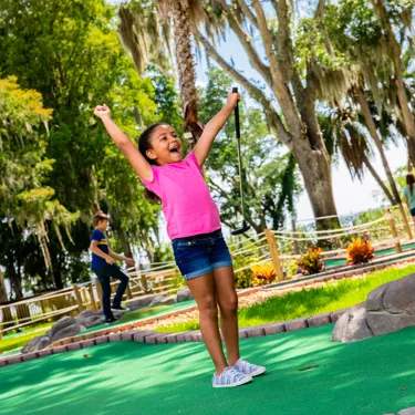 Girl Celebrates at Wild Side Mini Golf