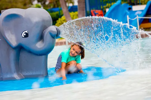 A young girl watching the DUPLO elephant spraying water at the DUPLO Splash Safari