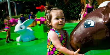 Young kids having fun at the DUPLO Splash Pad themed with farm animals at LEGOLAND Florida.