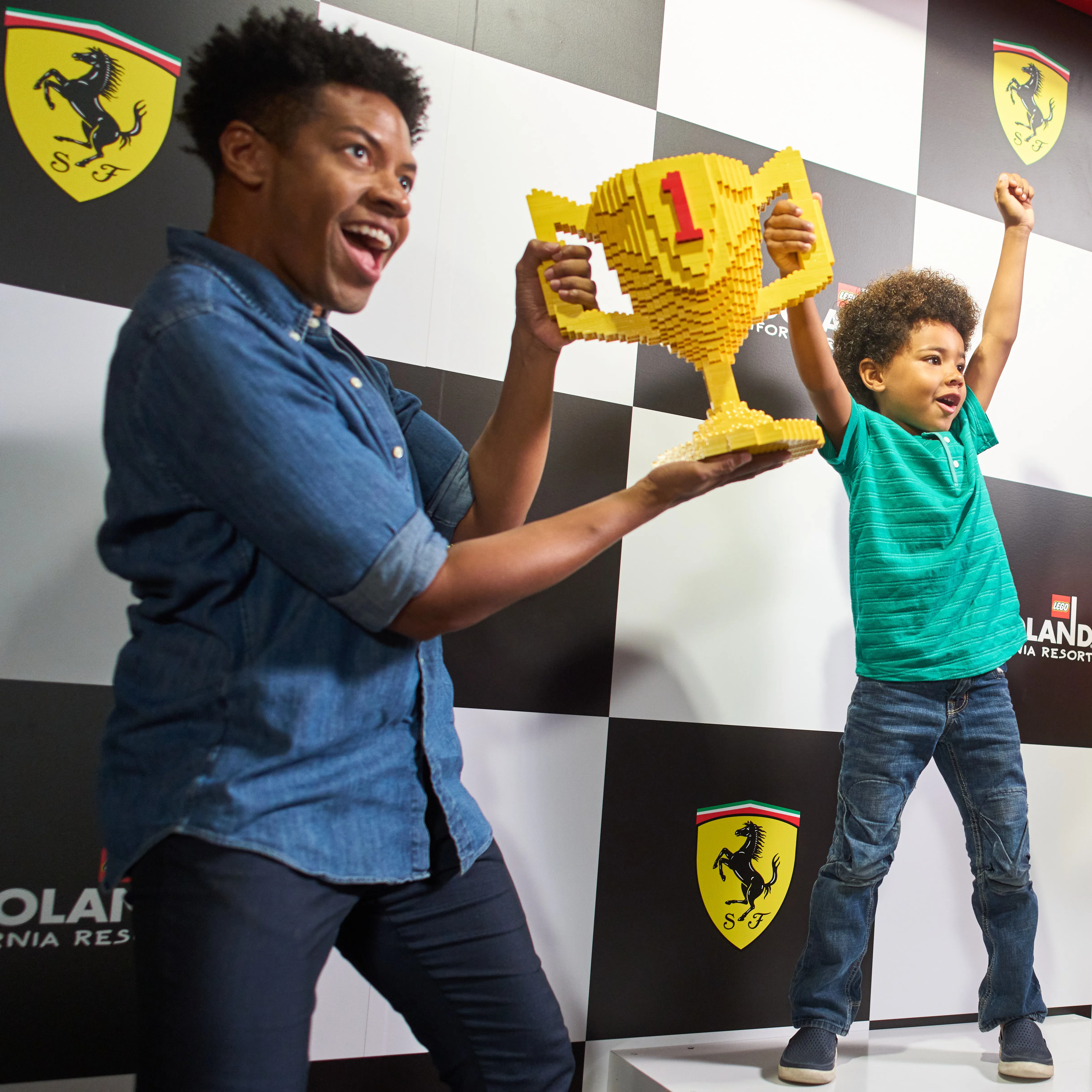 Father & Son holding LEGO Trophy at Ferrari Build and Race