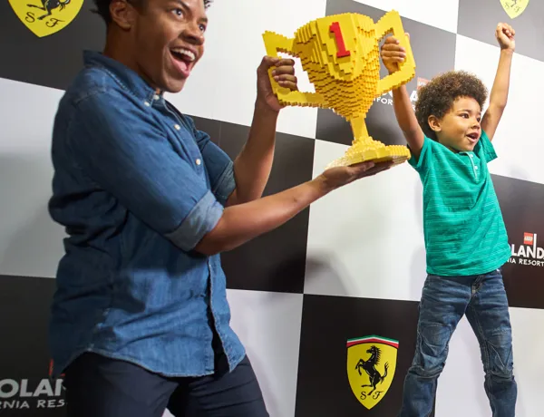 Father & Son holding LEGO Trophy at Ferrari Build and Race