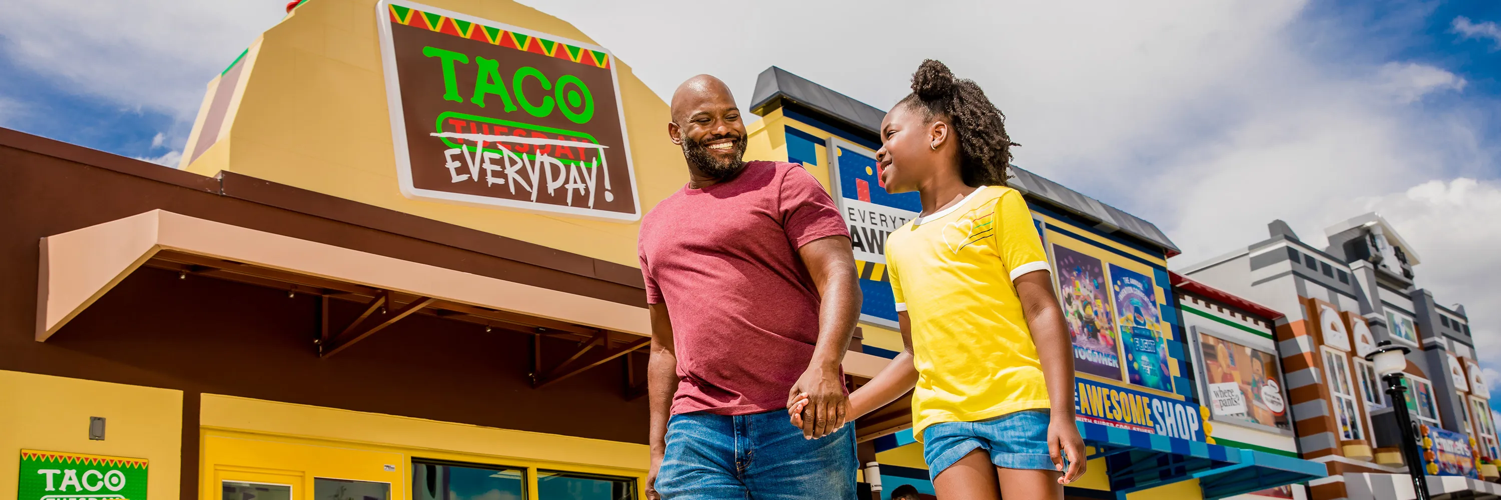 Dad and Daughter walking in front of Taco Everyday