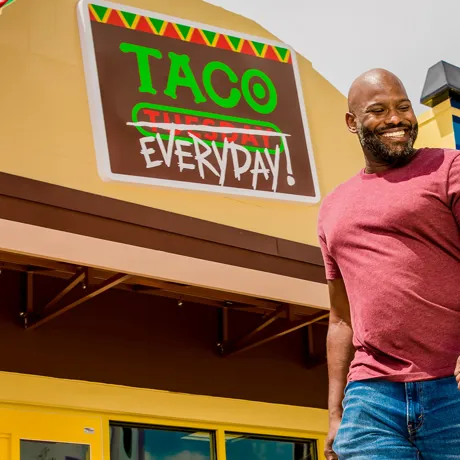 Dad and Daughter walking in front of Taco Everyday