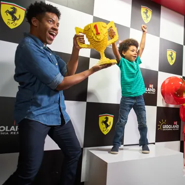 Father & Son holding LEGO Trophy at Ferrari Build and Race