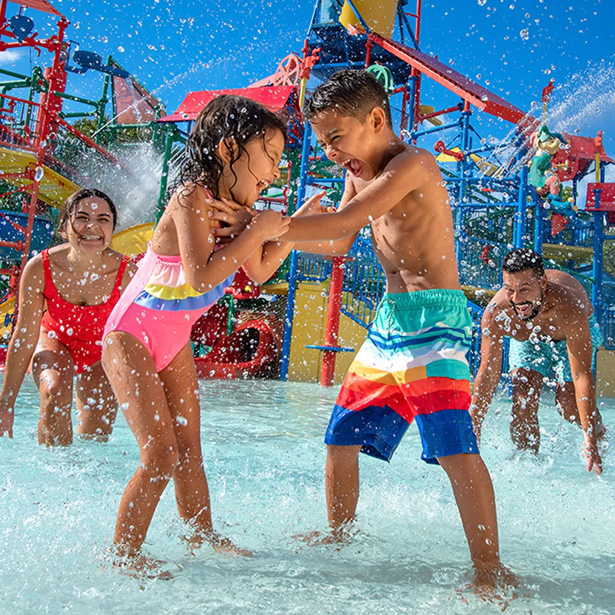 Two children splashing and playing together at a LEGOLAND water park