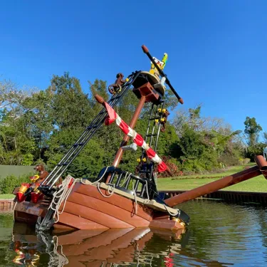 A LEGO® pirate ship tilted in the water at LEGOLAND® Florida, part of the pirate boat ride.