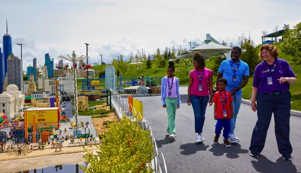 VIP Host walking family through MINILAND