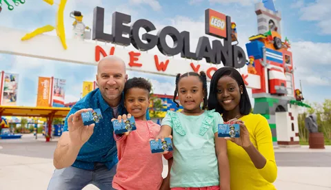 Family showing annual passes at the entrance of LEGOLAND New York
