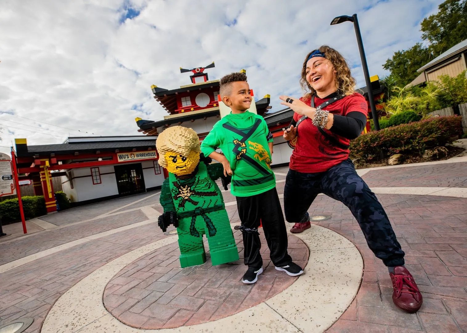 Kid with Ninja in front of LEGO NINJAGO Ride