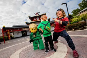 Kid with Ninja in front of LEGO NINJAGO Ride