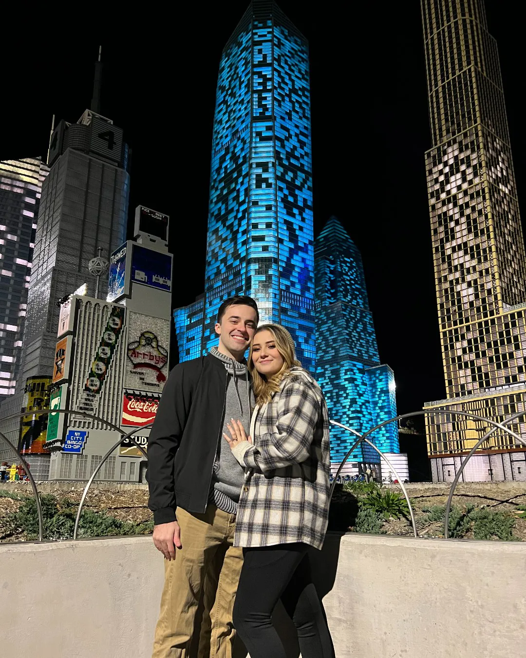 Couple poses in Miniland at Adult Night Event