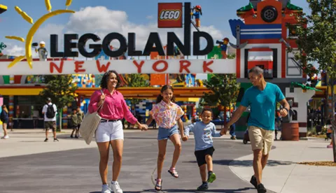 Family walking in front of LEGOLAND New York front gate