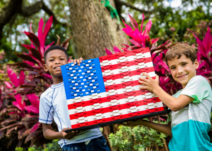 Boys holding up LEGO American Flag