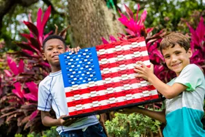 Boys holding up LEGO American Flag