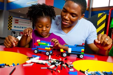 Family playing with LEGO Bricks