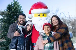 Family with LEGO Santa outside at Holiday Bricktacular
