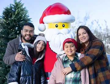 Family with LEGO Santa outside at Holiday Bricktacular