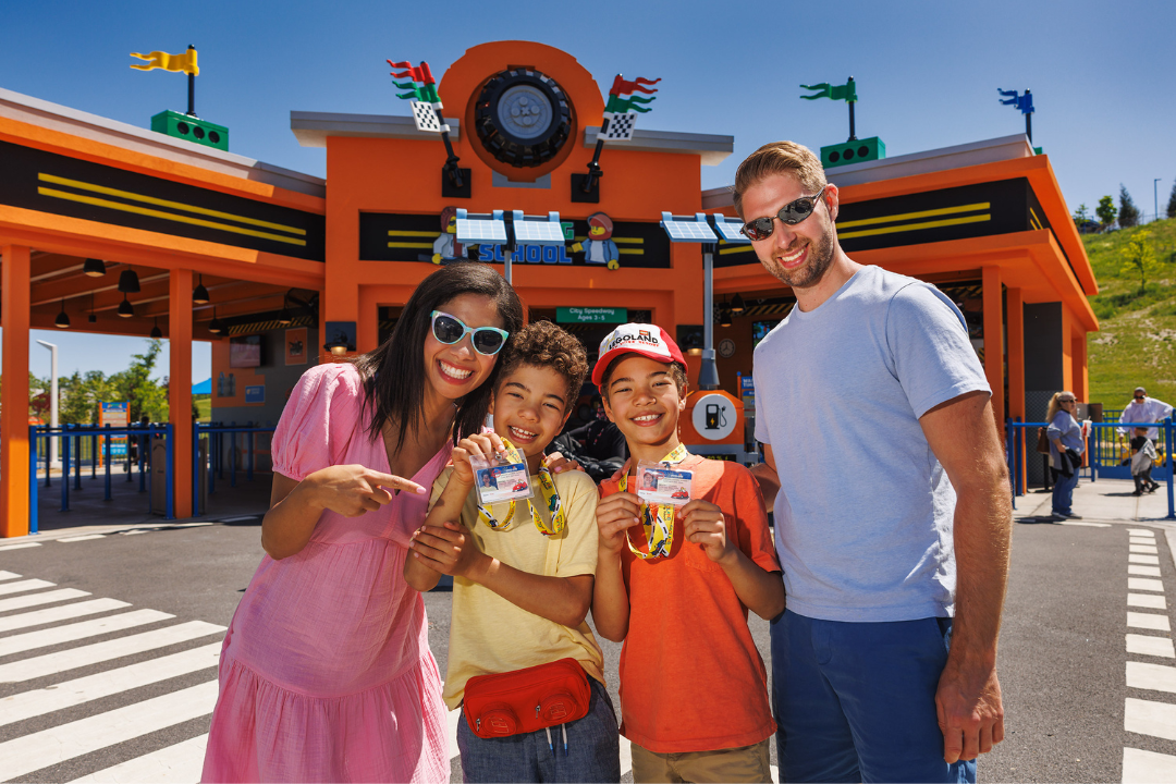 Family of Four posing in front of Driving School at LEGOLAND New York