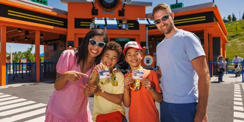 Family of Four posing in front of Driving School at LEGOLAND New York