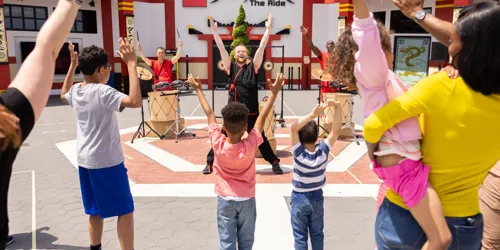 Kids ready for a ninja-inspired music and drum show at Earth Beat
