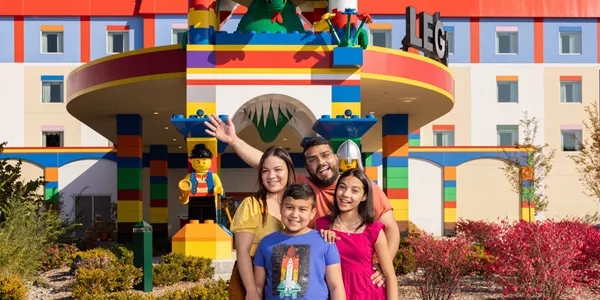 Family poses for a photo at the LEGOLAND Hotel entrance