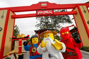 NINJAGO Characters in front of LEGO NINJAGO Sign
